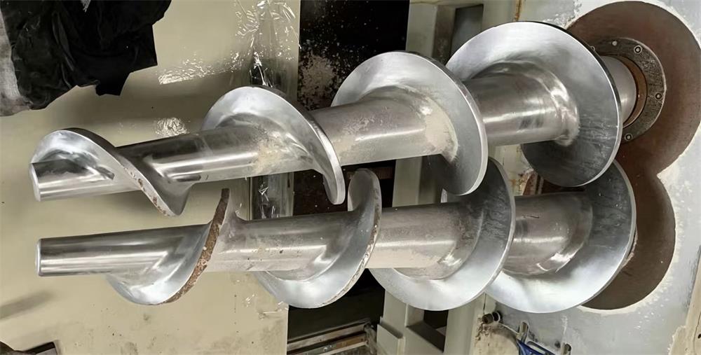 Welded screw conveyor auger flight shaft with multiple helical flights assembled for industrial use