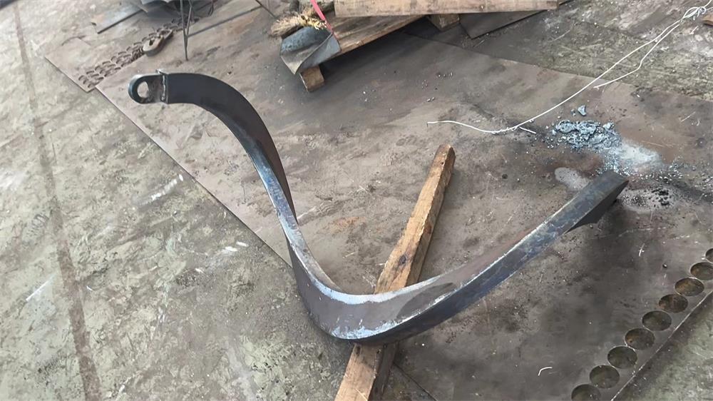 Formed sectional screw flight plate showing helical blade shape for screw conveyor manufacturing